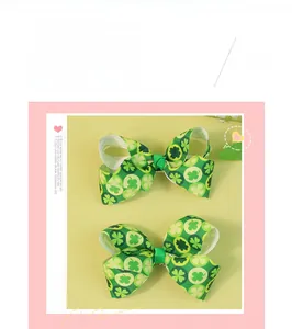 Detail of two handmade green shamrock hair bows with clover patterns for St. Patrick's Day