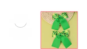 Detail view of Saint Patrick's Day green bow hair clips with clover patterns in a set of two