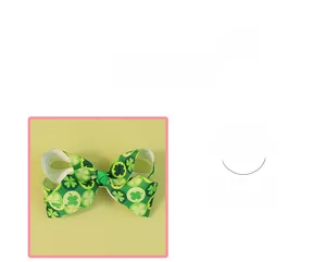 Detail of green ribbon hair bow with shamrock patterns for St. Patrick's Day celebration
