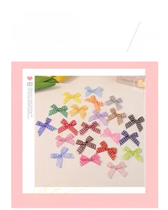 Detailed view of colorful 2cm plaid bows made of tartan ribbon for DIY craft projects