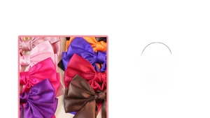 Detail view of colorful satin bow hair clips in pink, purple, and orange silk fabric