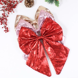 Large sequin Christmas bow ornaments in red, gold and pink for festive tree decoration