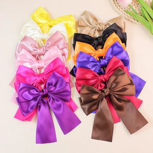 Collection of oversized satin bow hair clips with long ribbons in twelve vibrant colors