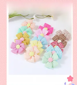Detailed view of checkered plaid fabric flowers in pastel colors for DIY hair accessories