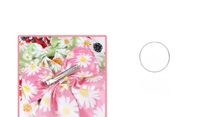 Close-up of fabric daisy print bow hair clip with a silver metal duckbill base