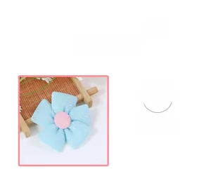 Detail of light blue plaid fabric five-petal flower with pink center and silver glitter