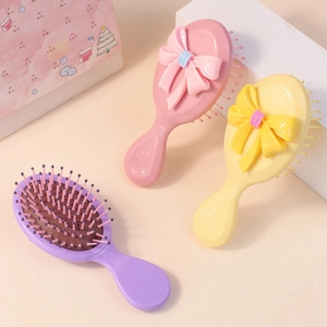 Mini spazzole per capelli colorate con fiocco e morbido cuscino d'aria per bambine