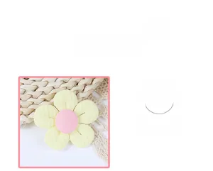 Detail of yellow fabric 3D flower accessory with pink stamen and white lace on straw