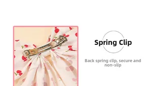Detail view of cherry print bow hair clip featuring a secure silver metal spring clasp