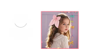 Detailed view of a pink polka dot bow hair clip accessory worn on girl's side hair