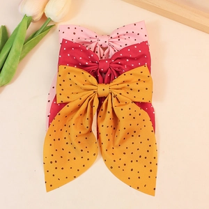 Sweet polka dot bow hair clips with long streamers in pink, red, and yellow colors