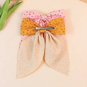 Polka dot bow hair clip set in pink and yellow with silver duckbill clips for women