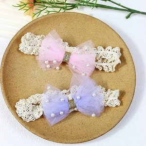 Two-pack of elastic baby headbands with large mesh bows and pearl embellishments