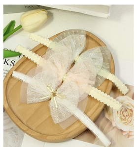 Detailed set of three lace baby headbands with mesh bows in ivory pink and mint colors