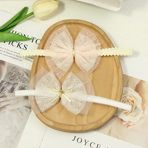 Two-pack baby girls lace bow headbands with mesh star detail in pink and white