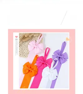 Detail of colorful grosgrain ribbon organizers for kids' hair bows in five vibrant colors