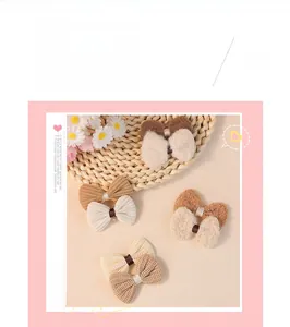 Detailed close-up of brown velvet and corduroy bow hair accessories in earth tones