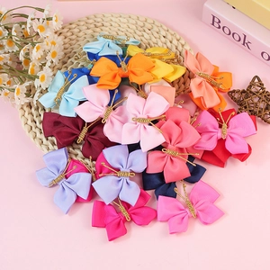 Handmade grosgrain ribbon butterfly hair clips in various bright colors on a round mat