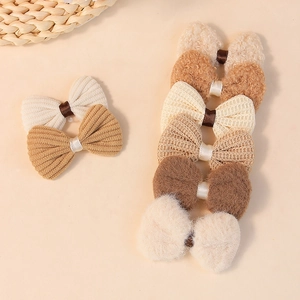 Assorted brown fabric bow hair accessories in wool, corduroy and knit textures