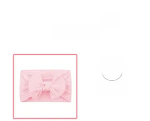 Detail of baby pink cable knit headband showing elastic texture and large soft bow knot