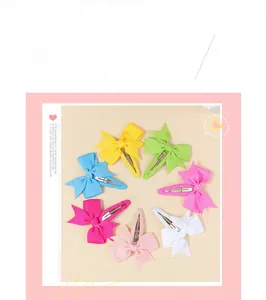 Detail view of seven colorful grosgrain ribbon bow clips for girls in pastel shades