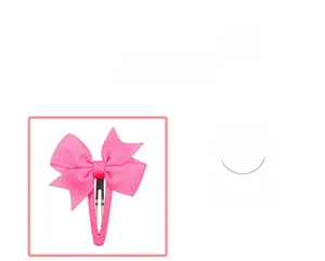 Detail of a bright pink bow hair clip with ribbed texture fabric and secure metal clasp