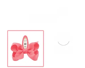 Detail showing the ribbed texture of the coral pink fabric bow hair clip with metal base