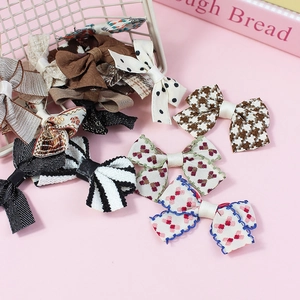 Various handmade polyester bow accessories in plaid and floral patterns for hair or shoes