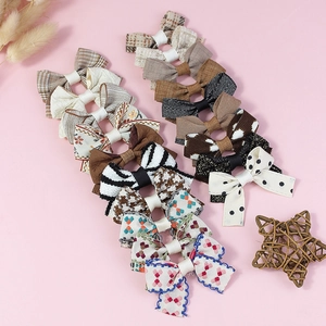 Set of assorted polyester bow hair accessories with plaid, floral and dot patterns