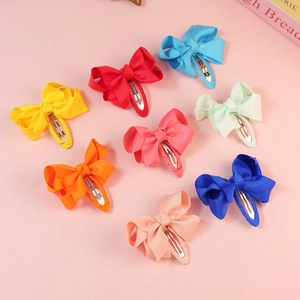 Set of 8 colorful 7cm ribbed fabric bow hair clips for girls in various candy colors