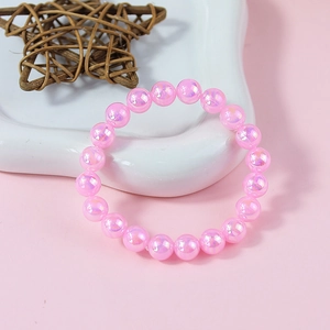 Close-up of pink iridescent pearl beads on a stretchy bracelet for girls