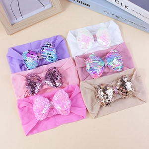 Colorful sequin bow baby headbands in purple, white, and pink elastic knit fabric