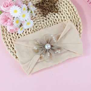 Elastic nylon baby headband with a beige tulle flower and white faux pearls