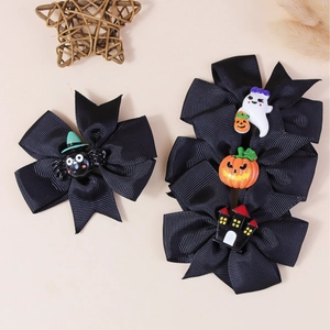 Handmade Halloween hair clips with spider and ghost charms on black grosgrain ribbons