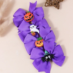Set of four purple Halloween bow hair clips with pumpkin and ghost resin charms