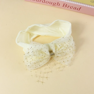 Elastic baby headband with large cream mesh bow and gold glitter grid pattern