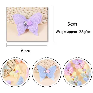 Colorful lace butterfly hair accessory with rhinestones and plush ball details