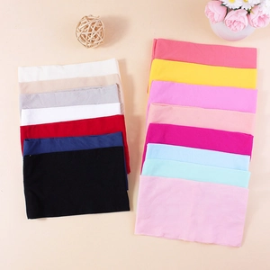 Multi-color stretchy nylon baby headbands with soft knit texture displayed on a warm beige background