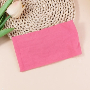 Detail showing the pink elastic nylon fabric texture of this baby headband accessory