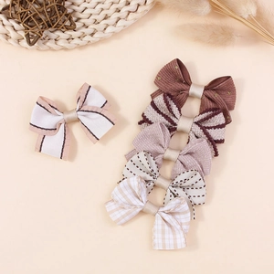 Set of handcrafted plaid and solid fabric bow hair clips in elegant neutral earth tones