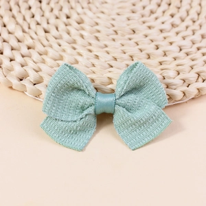 Close-up of mint green handmade fabric bow for DIY hair accessories and clothing