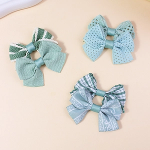 Set of handmade green checkered fabric bow hair clips for girls in mint and striped patterns