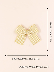 Detailed view of yellow plaid bow accessory with 6.5cm width and 5.5cm height measurements