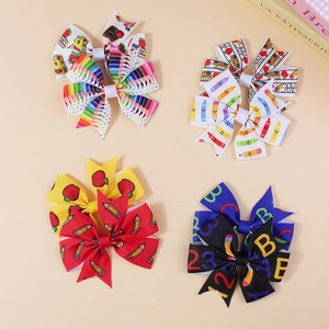 Set of four back to school themed hair bows with colorful pencil and apple prints