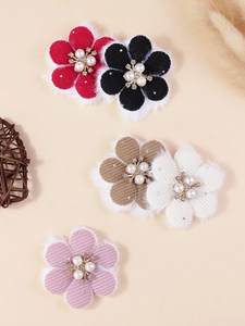 Detail of five fabric flower petals with corduroy texture, faux fur edge, and pearl center