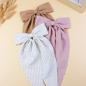 Three elegant striped oversized bow hair clips with long streamers in multiple colors