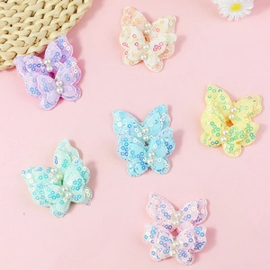 Sparkly sequin butterfly accessories with white pearls for DIY sewing and crafts