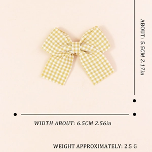 Yellow and white checkered fabric bow accessory with dimensions 5.5cm by 6.5cm