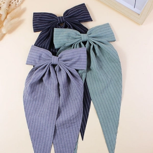Three striped fabric bow hair clips with long ribbons in navy blue, green and purple