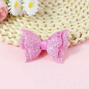 Detail of pink sequin butterfly bow accessory with glittering powder for DIY crafts